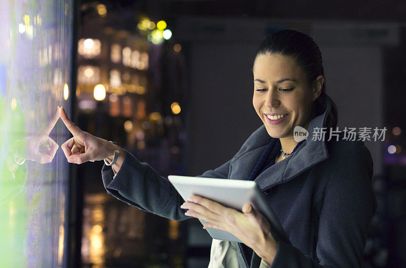 Tourist at night pointing on the map using digital tablet